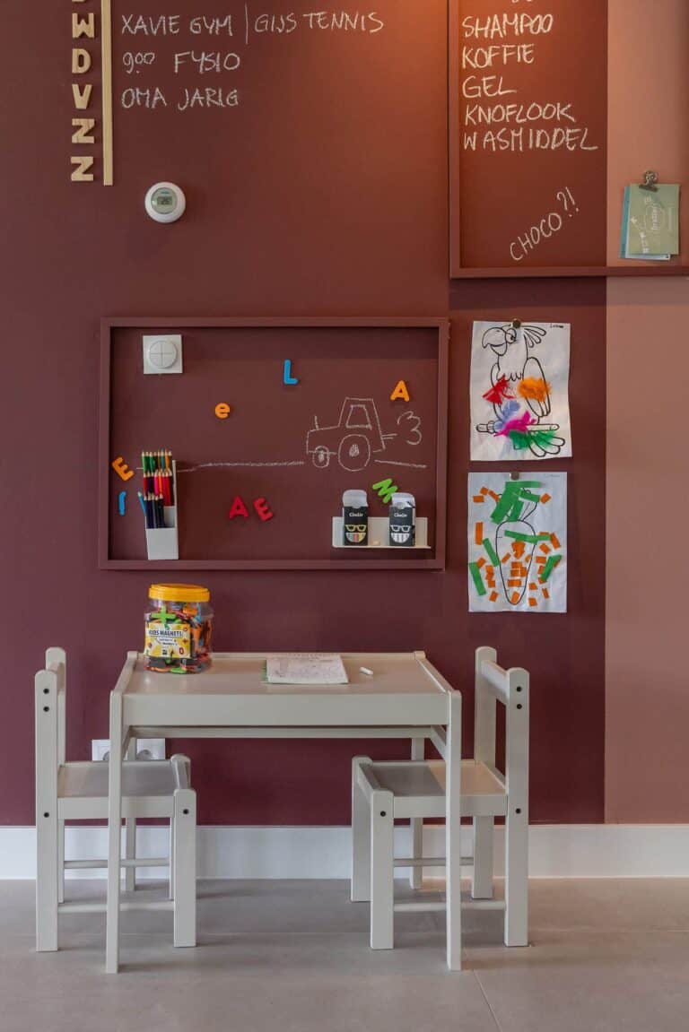Kinderzimmer mit weißem Kindertischchen und Stühlen an einer rosa Wand